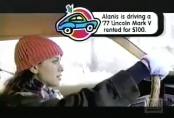 nostalgic pop-up video screenshot in these 90s pictures showing Alanis Morissette driving in the Ironic music video, complete with the iconic trivia bubble explaining she is driving a rented '77 Lincoln Mark V.