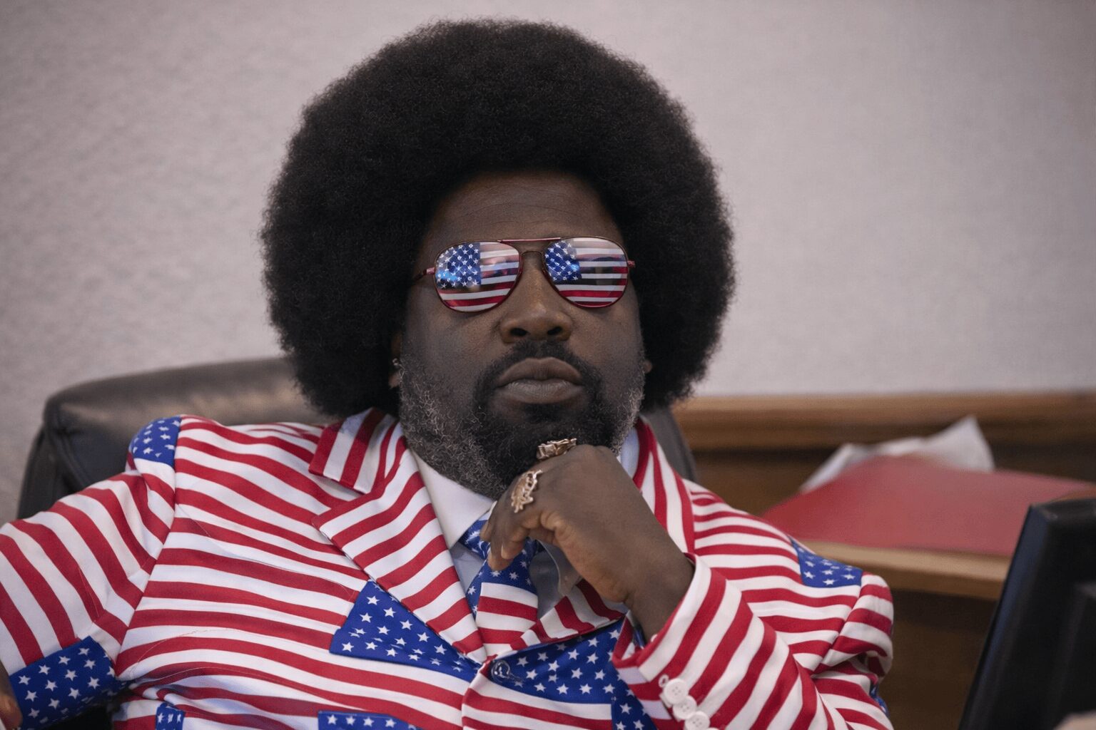 A roundup of Afroman trial memes featuring Afroman sitting in court wearing a loud American flag-themed suit and matching sunglasses, a sheriff's deputy with giant googly eyes staring intently at a lemon pound cake, and a parody movie poster titled "I Know You Want That Lemon Pound Cake Made By My Mother".