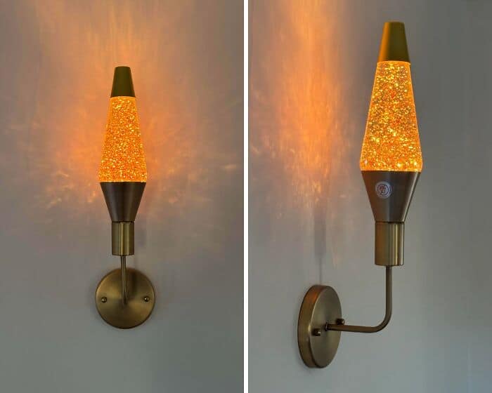 A bizarre wall sconce awkwardly constructed using the top half of a yellow glitter lava lamp. A prime example of a hilariously bad DIY lighting project.