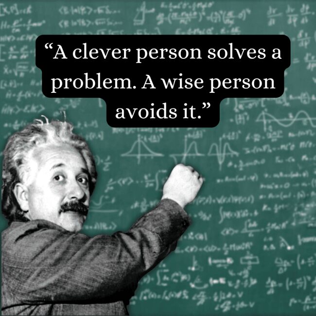 Distinguishing between quick fixes and true foresight, this albert einstein quote about cleverness versus wisdom is displayed over a rare photo of the physicist actively writing equations on a chalkboard with a piece of chalk.