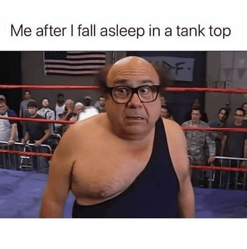 Frank Reynolds wearing a black wrestling singlet with one strap down, looking disheveled and completely confused.