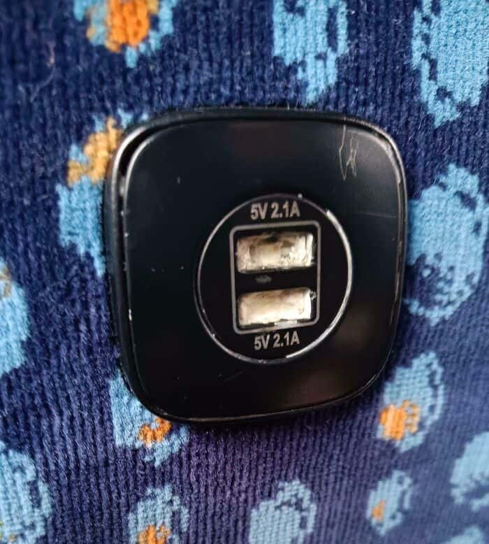 The sheer frustration of transit vandalism is clear in this close-up of a USB charging port stuffed with white gunk and gum, a mindless act by annoying people on public transit