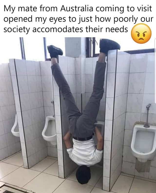 Humorous photo of a man standing on his head in a restroom stall labeled as Australian.