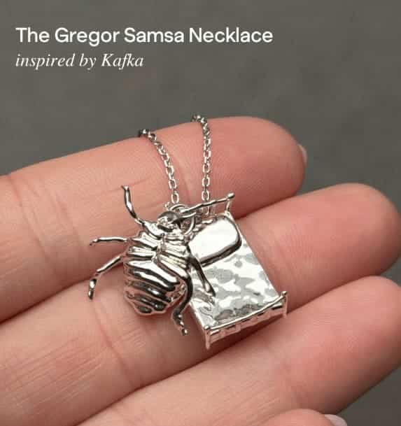 Silver necklace featuring Gregor Samsa from Kafka’s Metamorphosis as a large insect next to a bed.