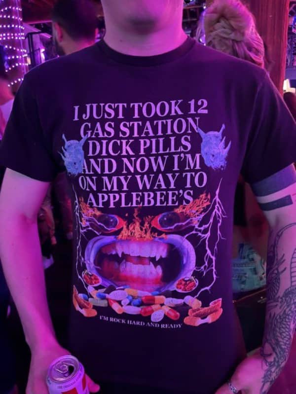 Person wearing a graphic tee about taking gas station pills and going to Applebee’s with intense imagery.