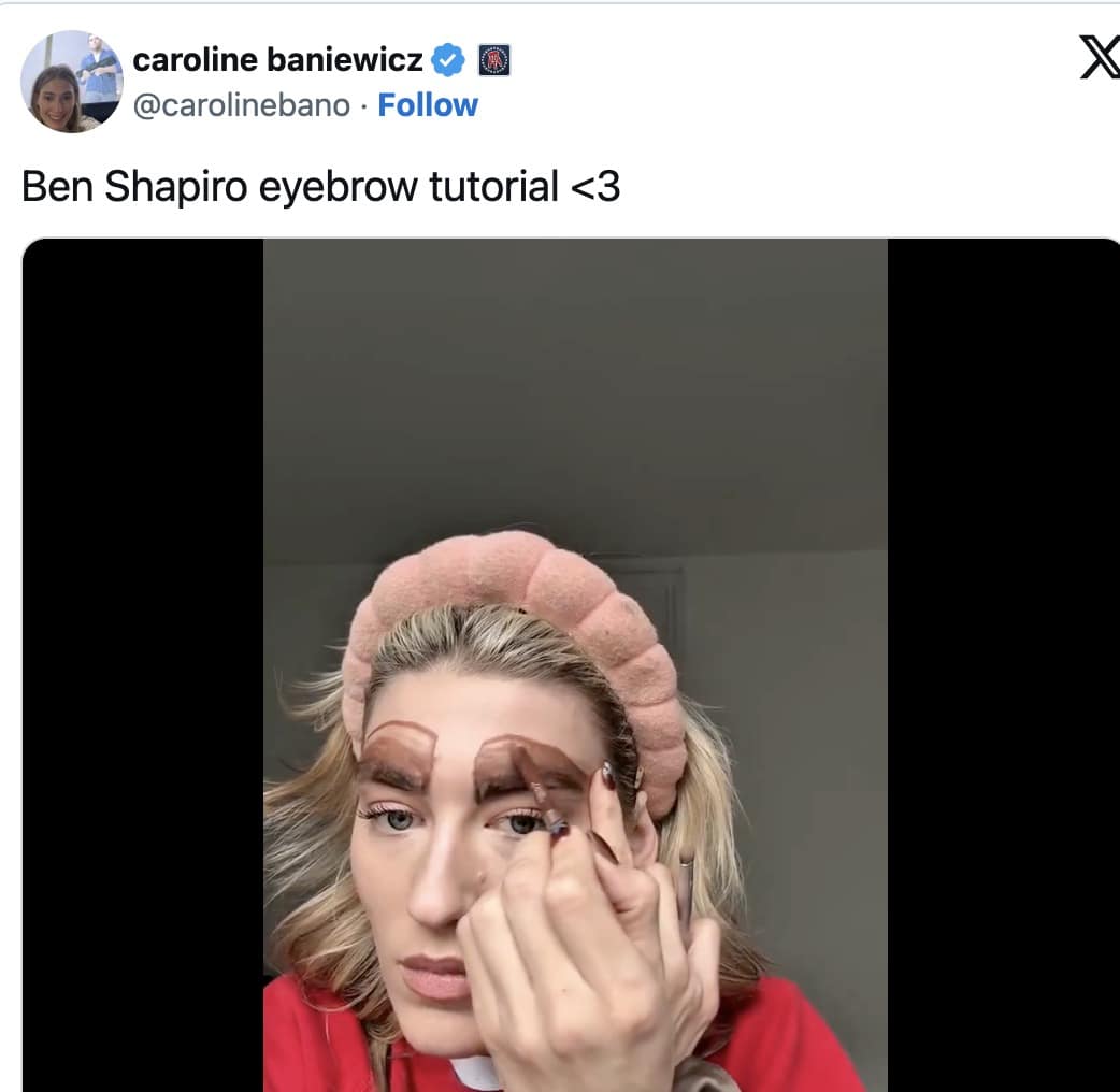 Ben Shapiro eyebrows meme featuring a woman using a makeup brush to draw massive, rectangular brown blocks on her forehead to mimic the commentator's viral 2026 aesthetic.