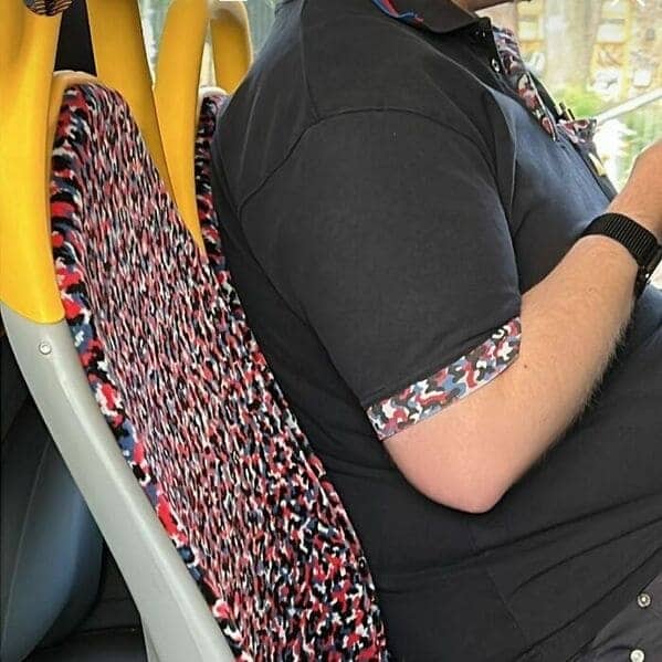 Man's polo shirt sleeve pattern perfectly matching the Berlin subway seat upholstery.