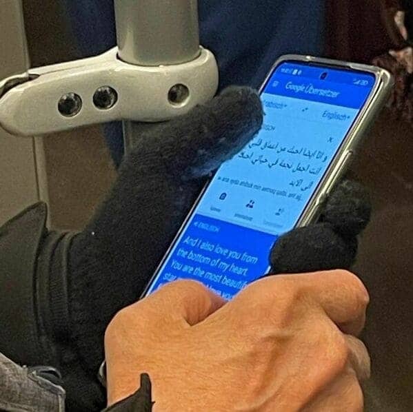 Close-up of a passenger using Google Translate to write a heartfelt love message.
