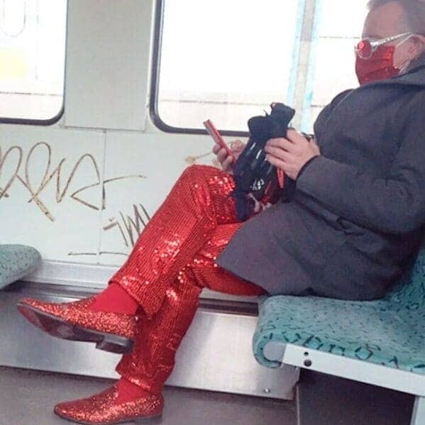 Passenger wearing a full sparkling red sequined suit and matching glittery red shoes.