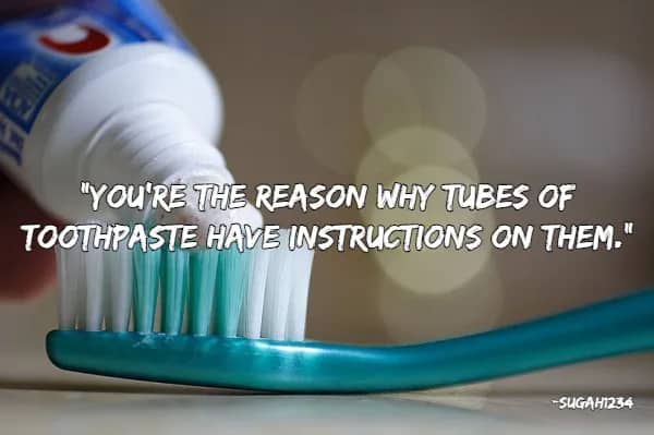Close up of toothpaste being squeezed onto a brush with a quote about needing instructional labels.