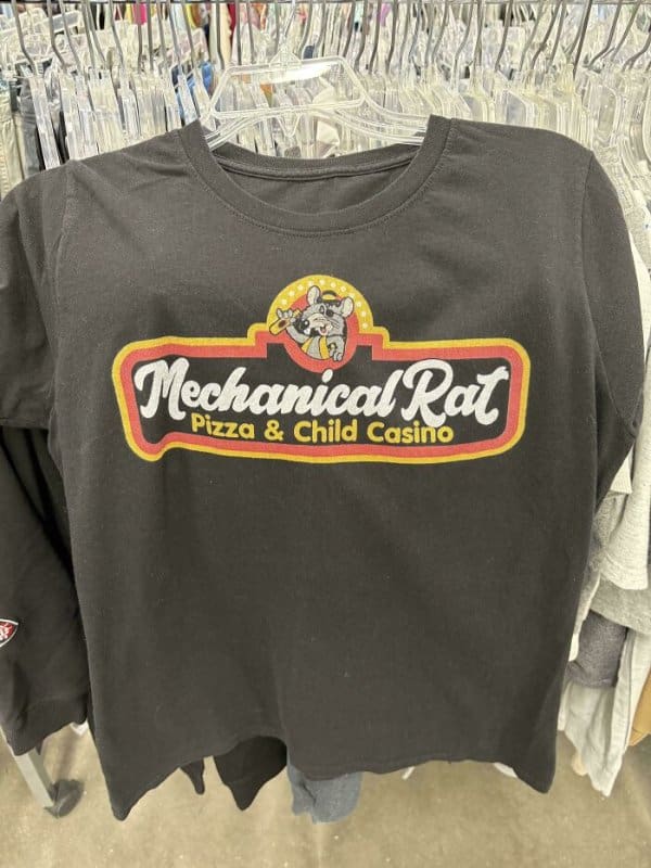 A black graphic tee that parodies the Chuck E. Cheese logo, instead reading "Mechanical Rat: Pizza & Child Casino" in the iconic red and yellow font.