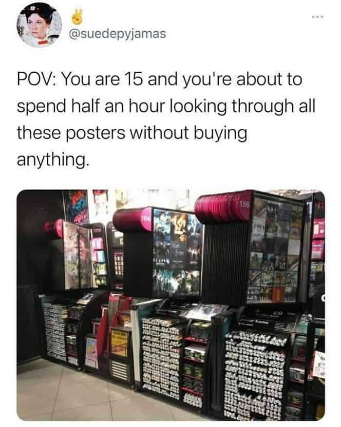 A nostalgic british meme from user @suedepyjamas showing the classic metal poster display racks found in UK shops like HMV or Woolworths. The caption captures a universal experience: "POV: You are 15 and you're about to spend half an hour looking through all these posters without buying anything."