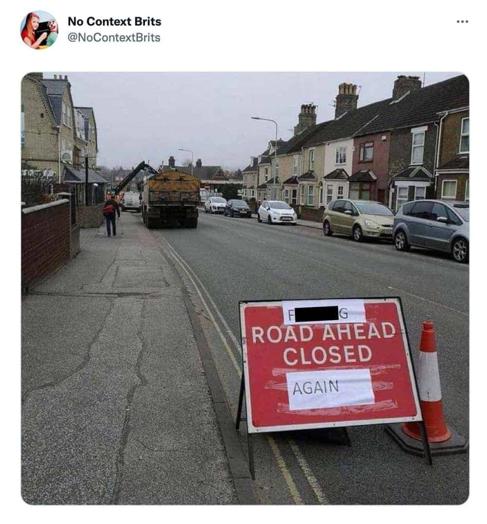 Exasperated British road closed again sign taped onto standard construction signage