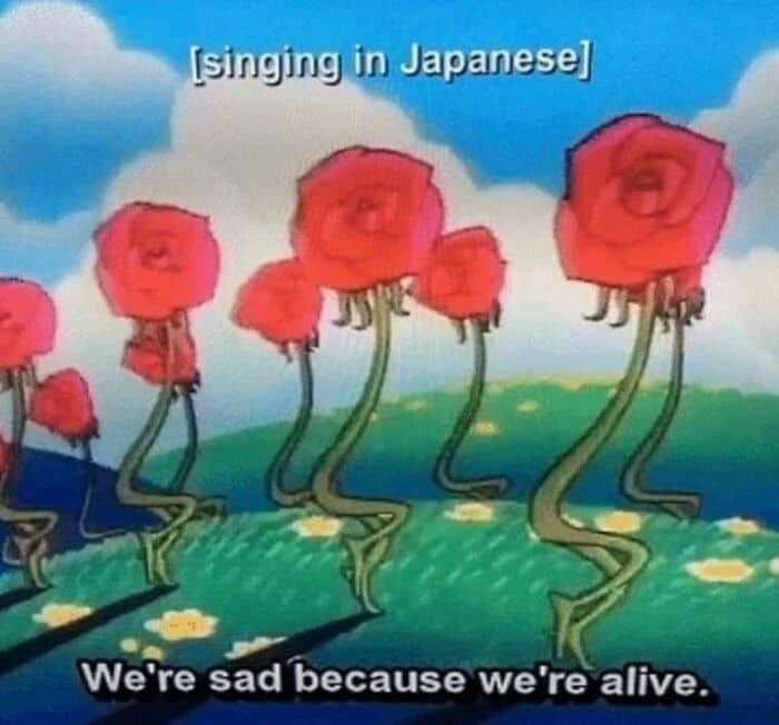 Cartoon roses singing in Japanese with a subtitle stating they are sad because they're alive.