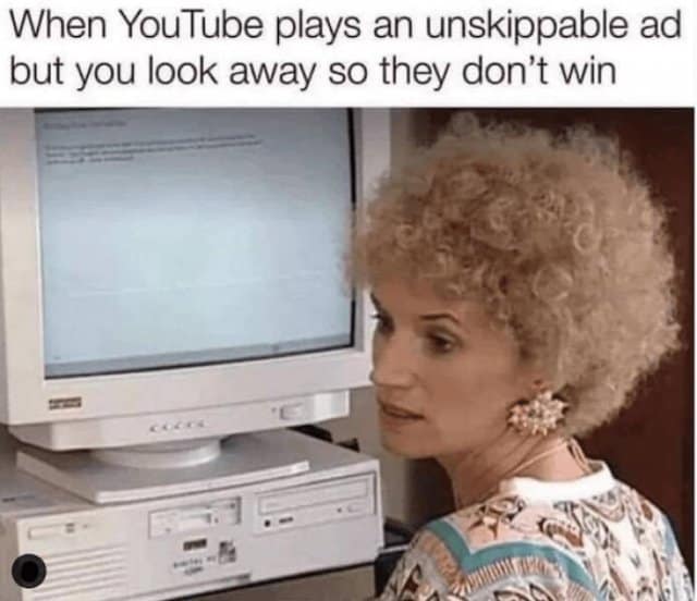 relatable classic meme showing a woman stubbornly looking away from her bulky retro computer monitor, capturing the petty victory of refusing to watch an unskippable YouTube ad, a brilliant addition to old memes.