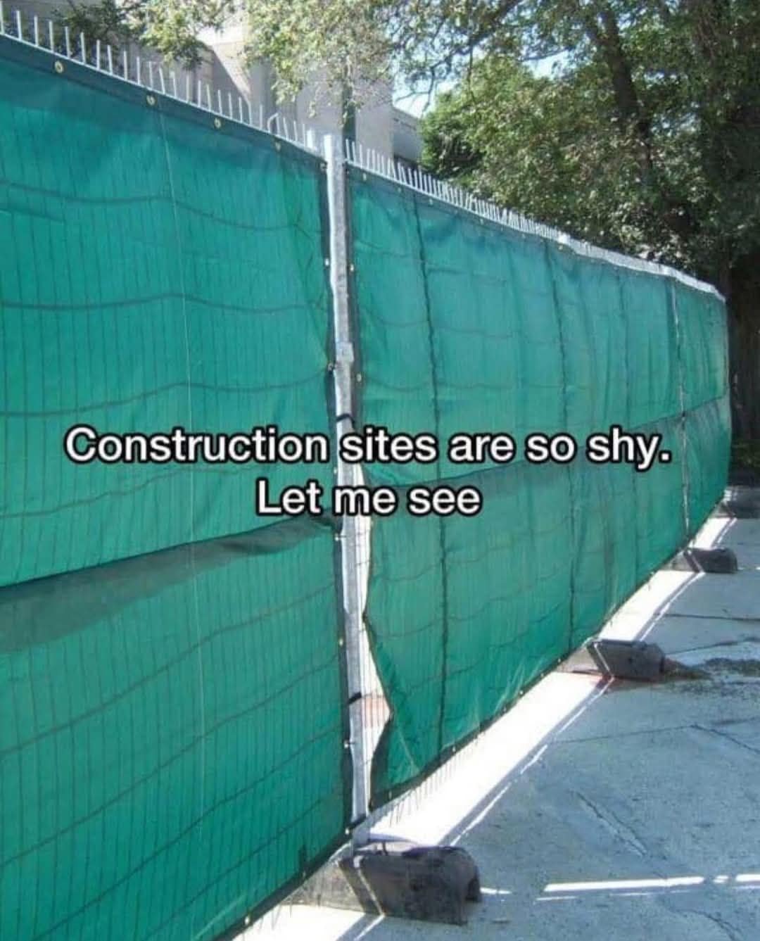 classic meme showing a green privacy fence around a construction site with a tiny gap, anthropomorphizing the site with the text saying construction sites are so shy let me see, proving that the urge to peek at heavy machinery is a universal theme in old memes.