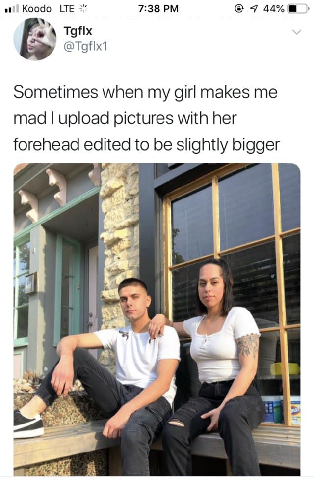 A "petty revenge" classic meme featuring a couple sitting on stairs. The caption admits, "Sometimes when my girl makes me mad I upload pictures with her forehead edited to be slightly bigger," and the photo shows a woman with a hilariously elongated, tall forehead.