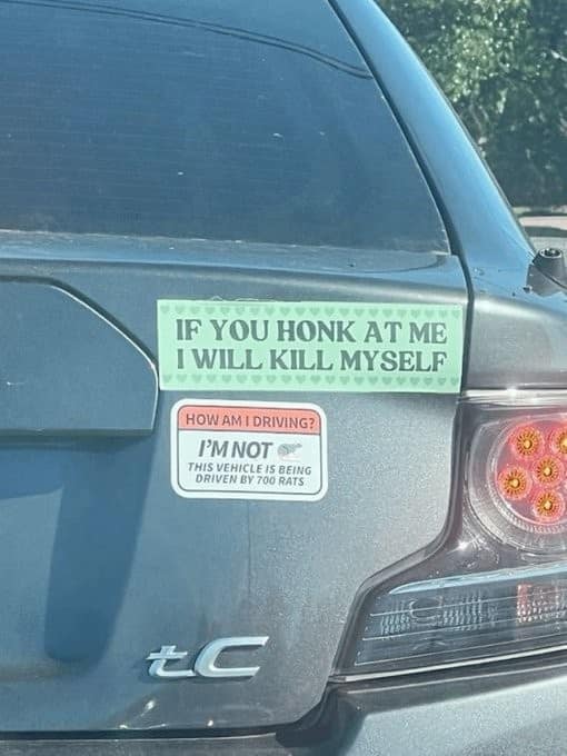 classic meme showing the back of a silver Toyota tC with two chaotic bumper stickers. The top green sticker warns, "IF YOU HONK AT ME I WILL KILL MYSELF," while a sticker designed like a "How's my driving?" sign below it reads: "I'M NOT THIS VEHICLE IS BEING DRIVEN BY 700 RATS."