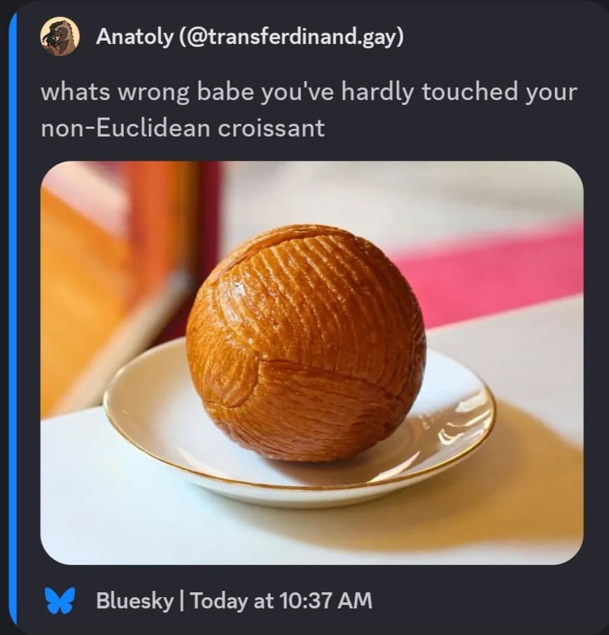 An absurdist classic meme featuring a perfectly spherical, intricately layered pastry dubbed a "non-Euclidean croissant" sitting on a white saucer.