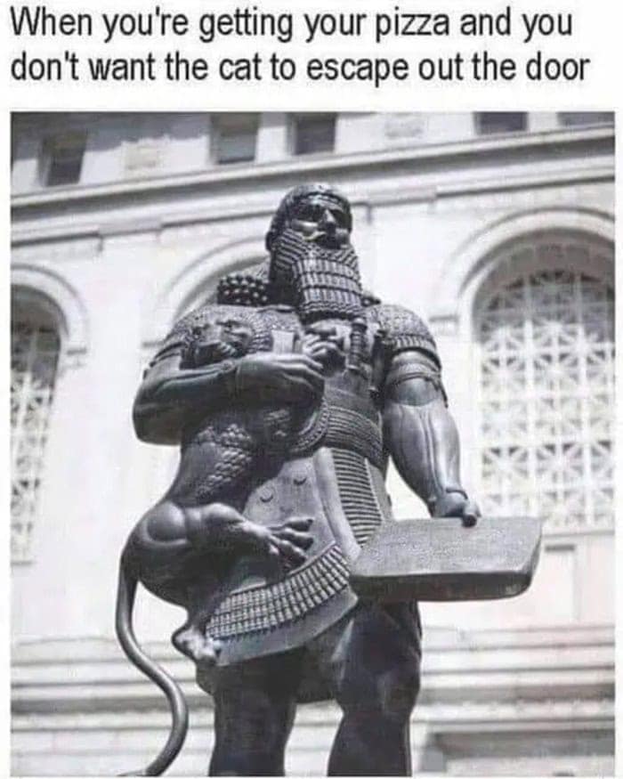 relatable classical art meme using an ancient Mesopotamian statue of Gilgamesh. The hero clutches a small lion tightly under his muscular arm while holding a flat tablet that looks exactly like a delivery box, captioned: "When you're getting your pizza and you don't want the cat to escape out the door."