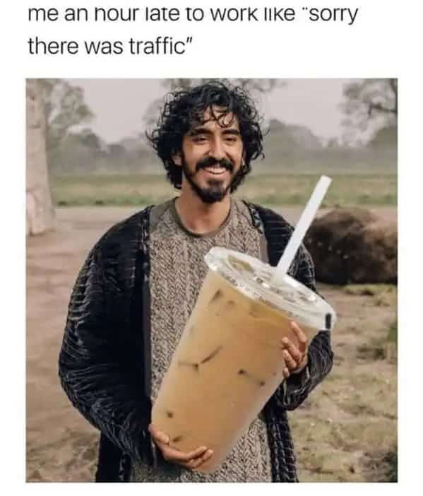 Dev Patel smiling while holding a massive oversized iced coffee with the caption about being late.