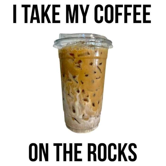 Close up of a swirling iced latte with the punny caption taking coffee on the rocks.