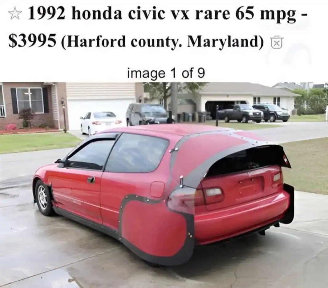 Red 1992 Honda Civic VX with custom aerodynamic rear wheel covers and a modified hatch extension.