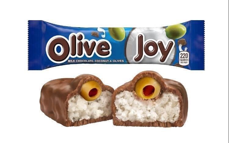 This cursed food image subverts the classic Almond Joy bar by replacing the almond with a pimento-stuffed green olive, aptly renamed "Olive Joy."
