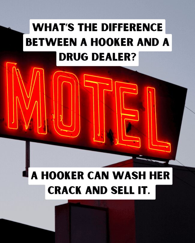 A glowing red neon motel sign featuring a dark joke about hookers and crack.