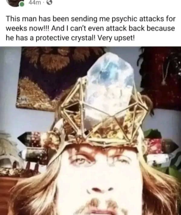 Man wearing a large crystal crown claiming to be under psychic attack on social media.