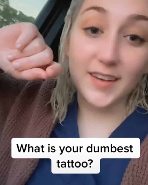 Woman in a vehicle posing a social media question about everyone's dumbest tattoo.