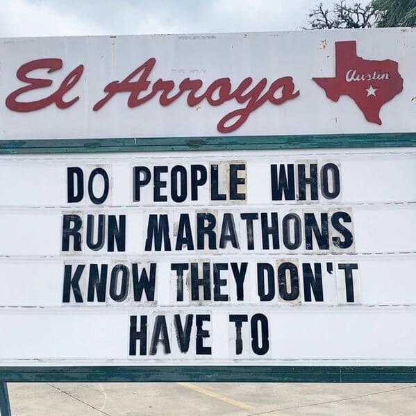 A funny restaurant sign displaying an el arroyo sign that aggressively asks do people who run marathons know they don't have to, perfectly capturing anti-fitness humor.