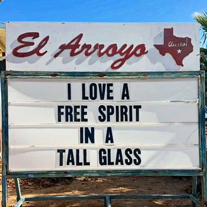 A hilarious el arroyo sign creatively declaring I love a free spirit in a tall glass, perfectly combining cocktail hour humor with a highly relatable funny restaurant sign.