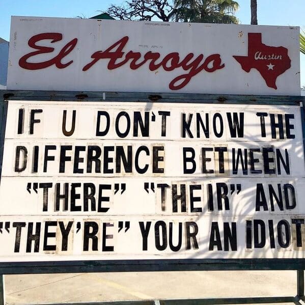 A grammatically ironic el arroyo sign brilliantly baiting the internet by stating if you do not know the difference between there, their, and they're, your an idiot on a funny restaurant sign.