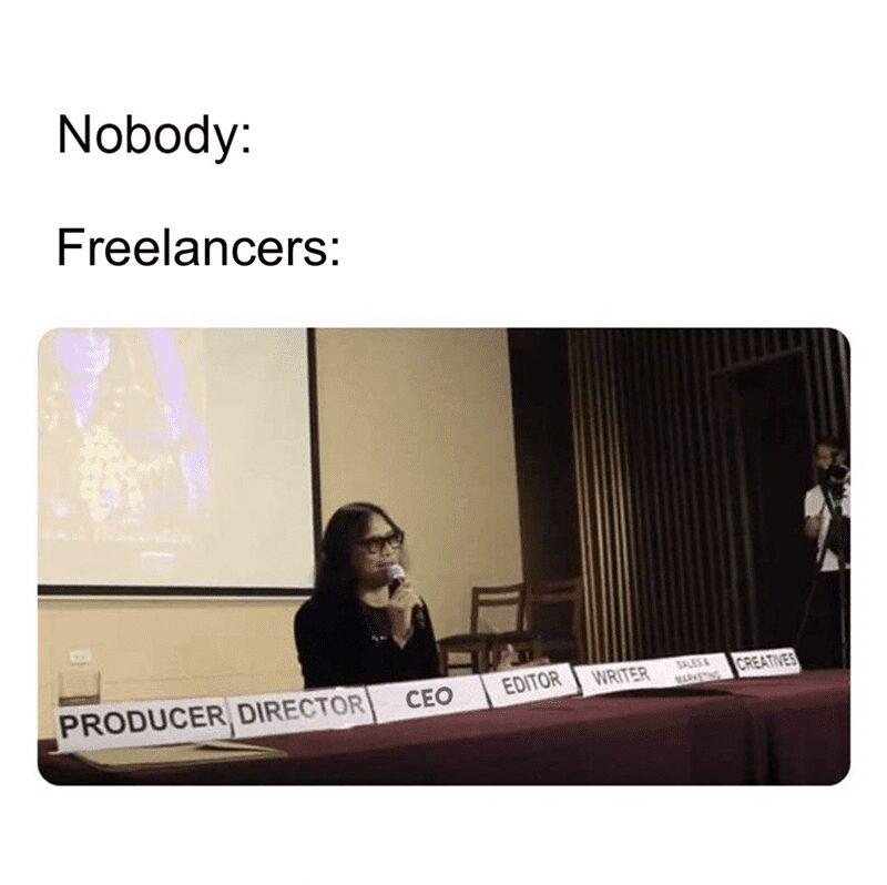 Woman sitting at a table with multiple nameplates including CEO, Editor, Writer, and Producer.
