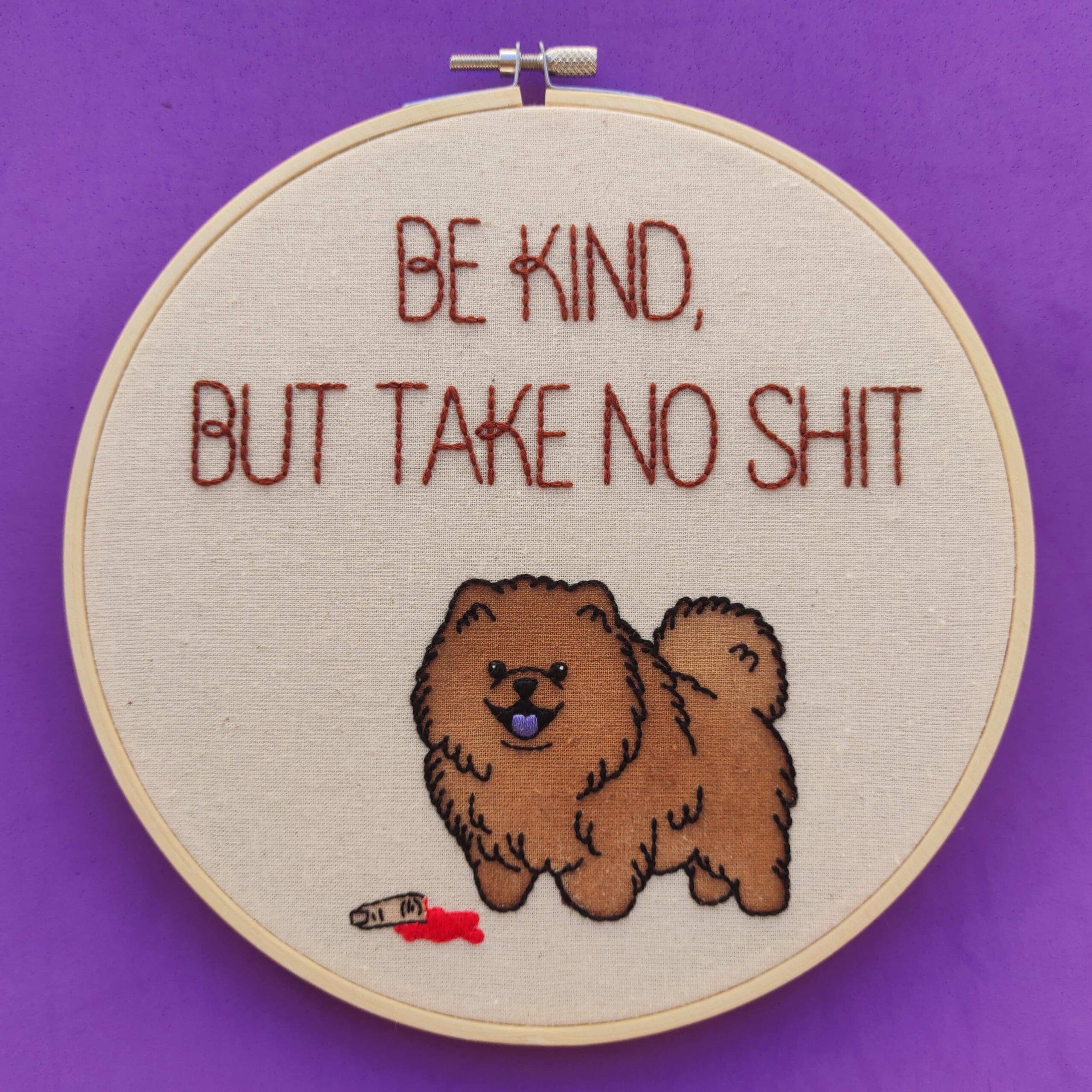 Needlework featuring a fluffy brown dog and the text "Be Kind, But Take No Sh*t."