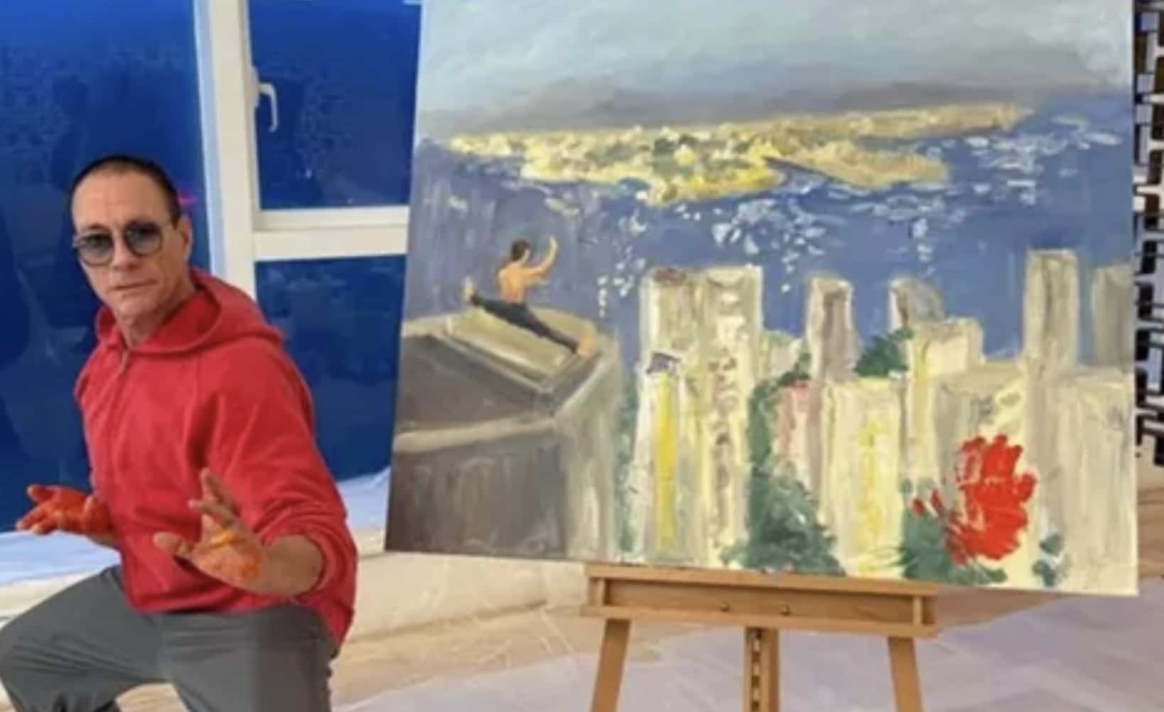 Jean-Claude Van Damme posing next to an oil painting of himself performing a rooftop split.