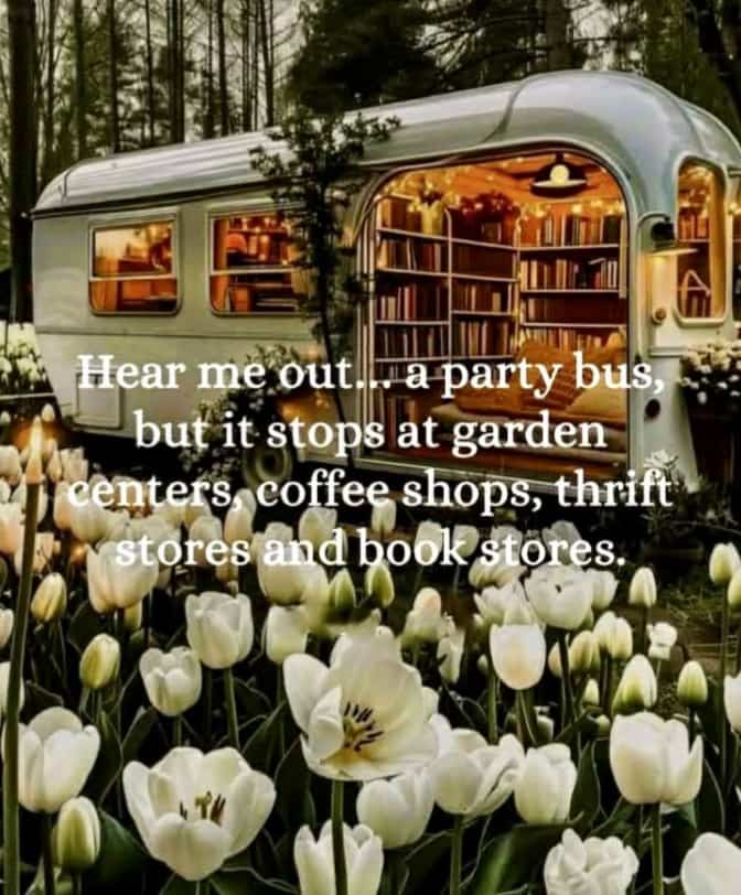 Aesthetic silver camper trailer converted into a cozy mobile library surrounded by white tulips in bloom.