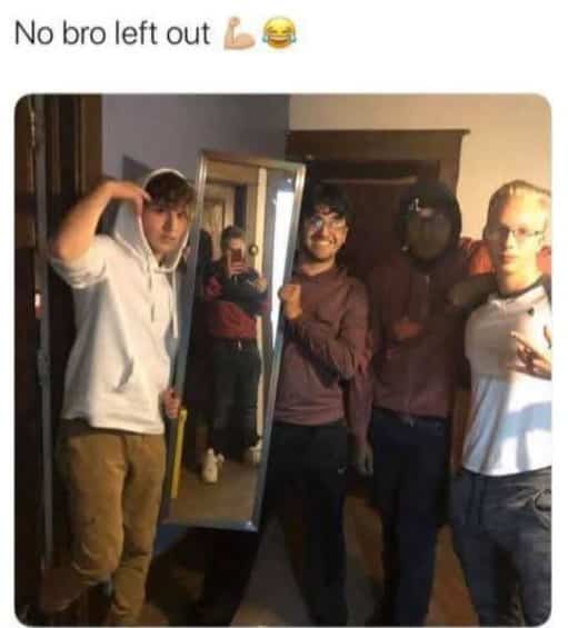 Group of friends posing for a photo while holding a mirror to include the person taking it.