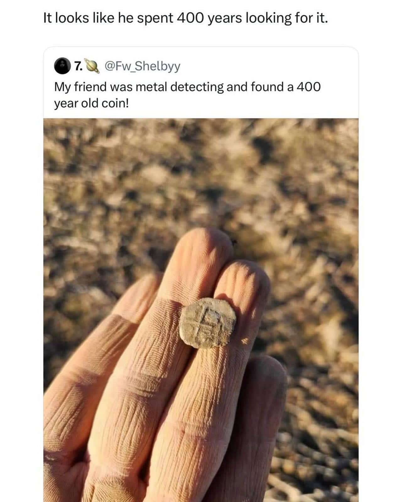 Social media post showing a metal detecting find of an old coin and wrinkled fingers.