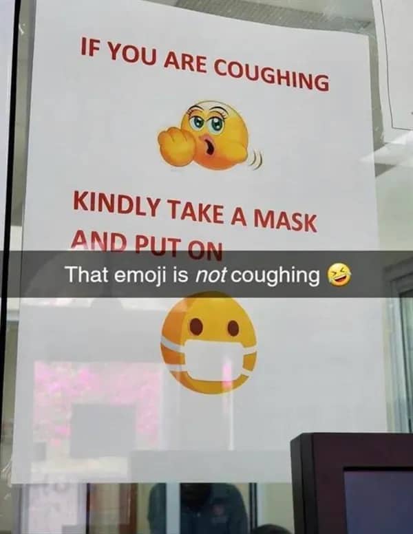 Public health sign with a suggestive emoji mistakenly used to represent a person coughing.