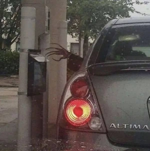 Creepy long-fingered hand reaching out from a car window at a drive-thru menu.