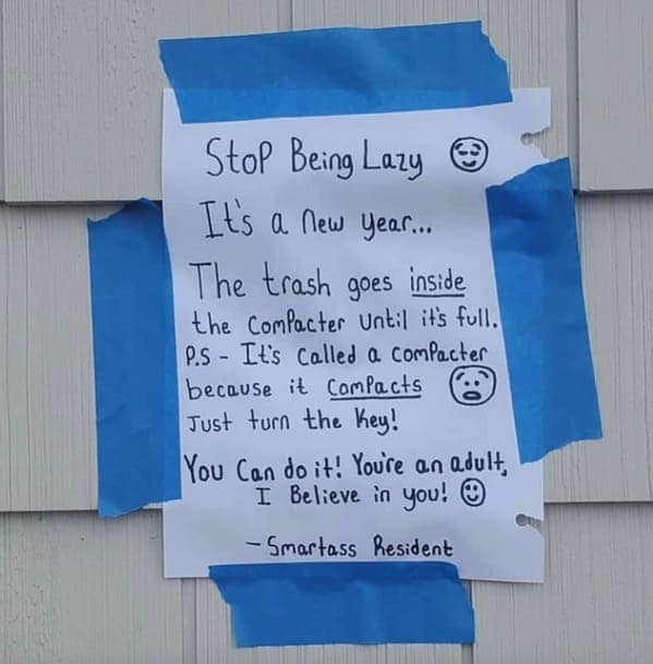 passive-aggressive note taped to a wall with blue painter's tape. It sarcastically instructs a neighbor on how a trash compactor works, telling them to "just turn the key" and ending with a mocking "You can do it! You're an adult, I Believe in you!" signed by a "Smartass Resident."