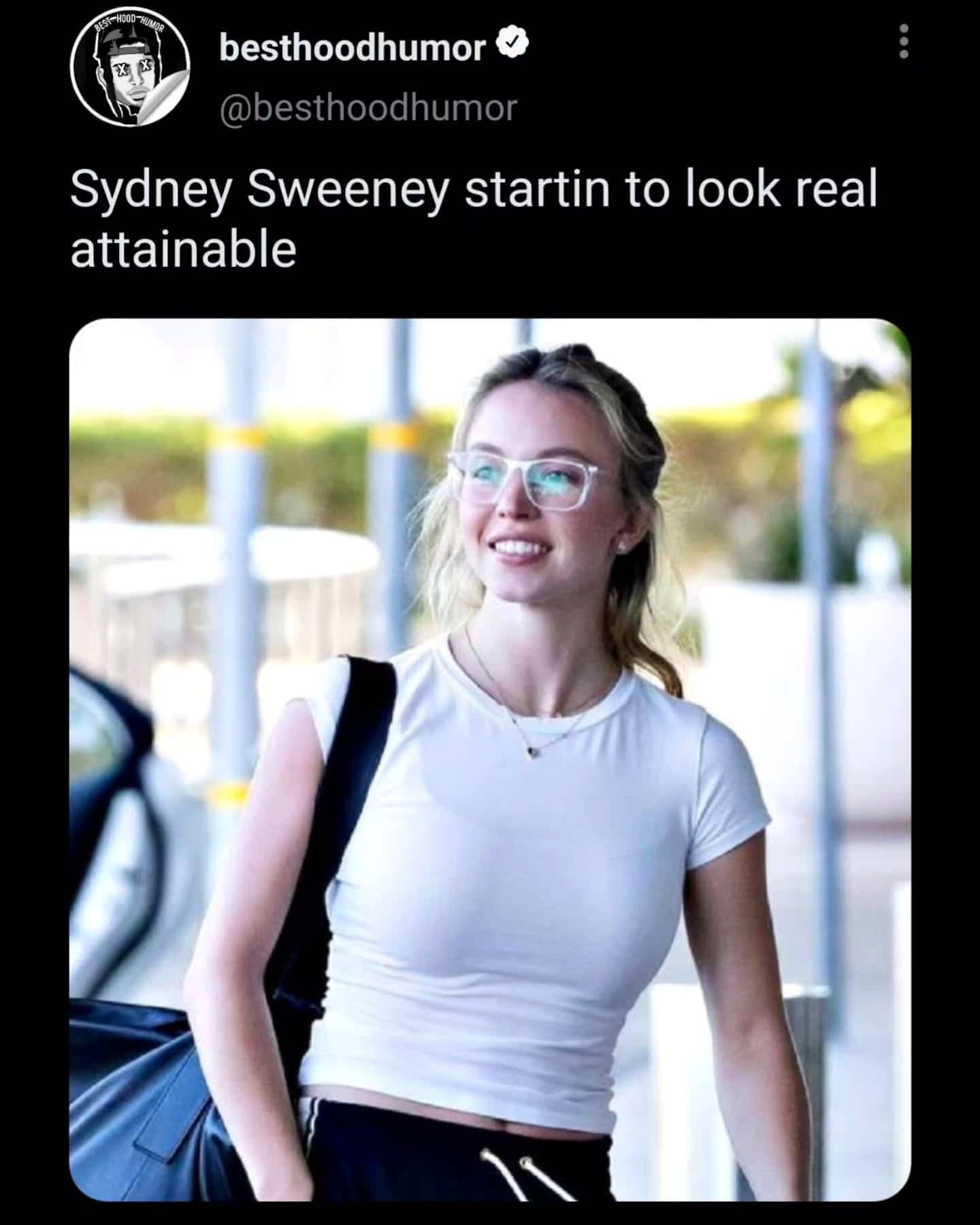 Actress Sydney Sweeney wearing glasses and a white t-shirt with a humorous social media caption.