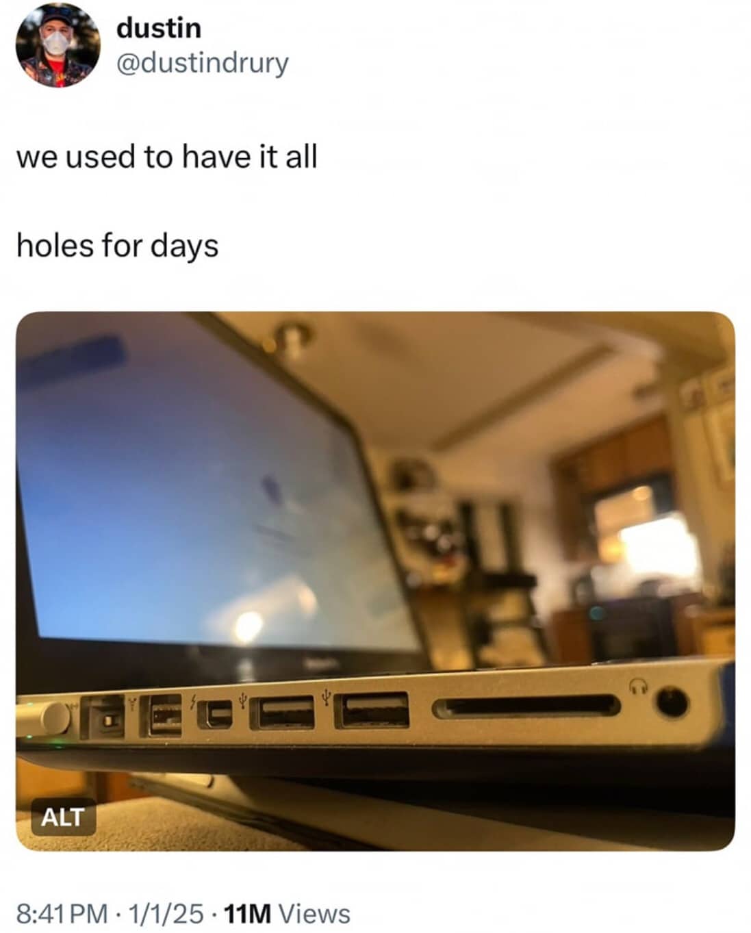 A close-up shot of an older laptop showing various ports, including USB and SD slots.