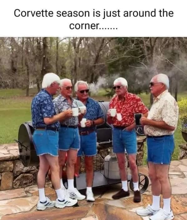 Group of older men wearing matching blue jean shorts and white sneakers during Corvette season.