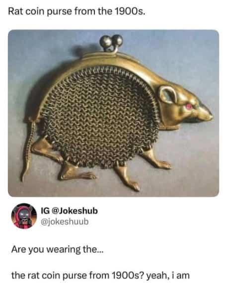 Unique vintage metal rat coin purse from the nineteen hundreds with a mesh body and red gemstone eyes.