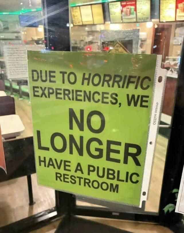 A blunt funny sign printed on bright green paper and taped to a storefront door. It offers an ominous warning for anyone seeking a bathroom break: "DUE TO HORRIFIC EXPERIENCES, WE NO LONGER HAVE A PUBLIC RESTROOM."