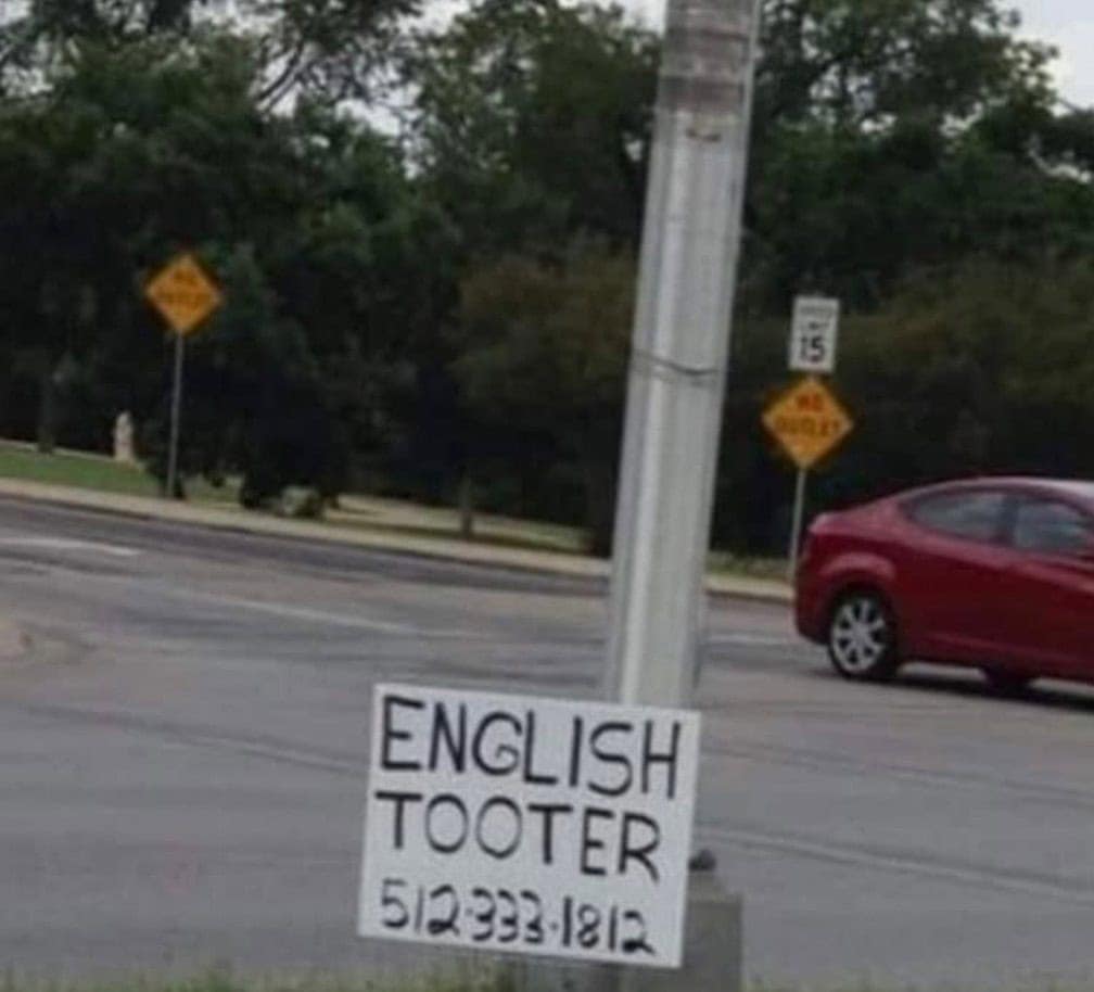 roadside sign that likely intended to advertise an "English Tutor" but hilariously offers the services of an "ENGLISH TOOTER" instead.