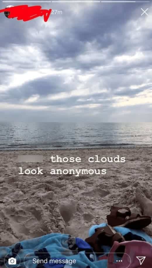 Beach photo caption stating that the clouds look "Anonymous" instead of "Ominous" over the ocean.